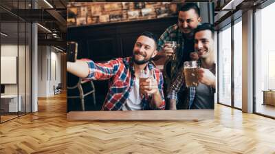 happy male friends taking selfie and drinking beer at bar or pub Wall mural